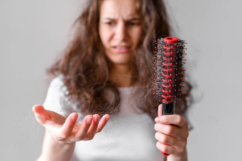 women struggling with hairfall